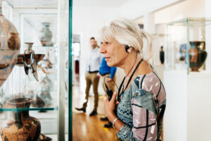 senior woman learning about artifacts